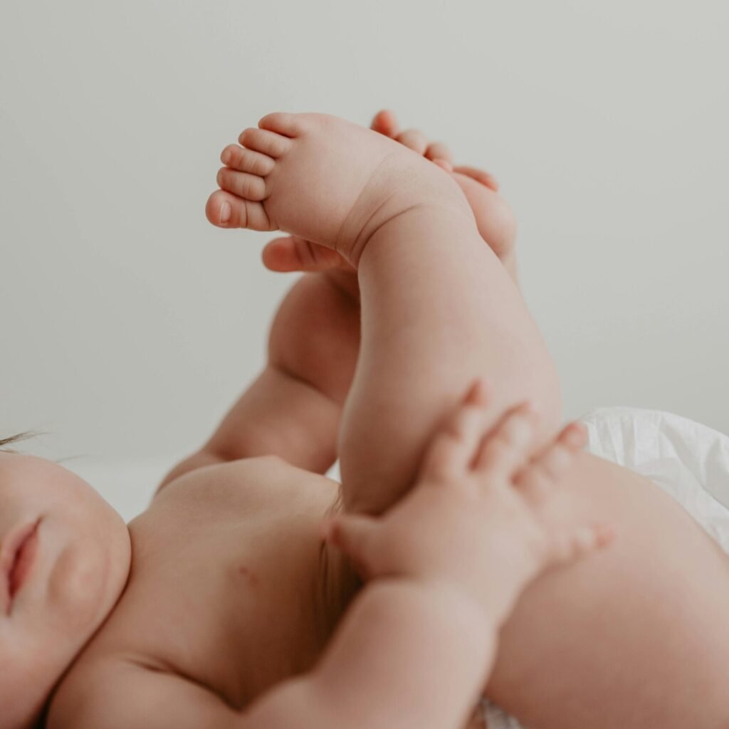 Heartwarming close-up of a baby lying down, focusing on tiny hands and feet.